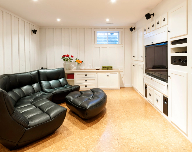 basement room with recliner sofas and theatre television and sound system