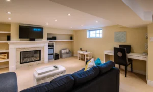 newly renovated basement converted to a relaxation room with wide television and fireplace